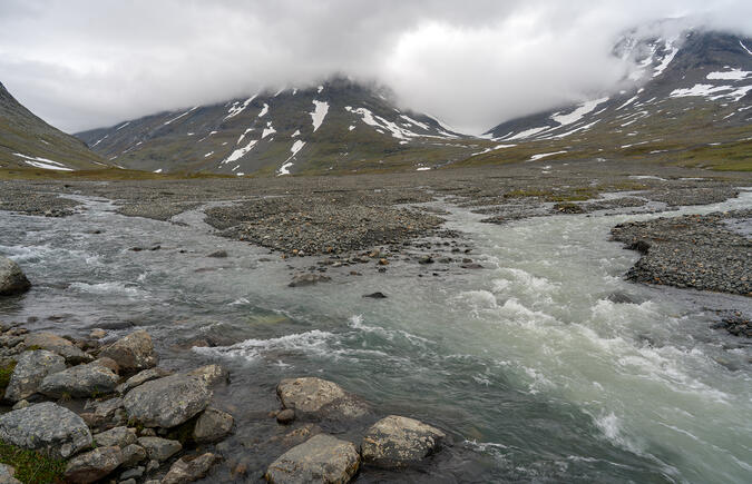 Det grumliga glaciärvattnet från Rijddajiegna blandas med det klarare vattnet från övre Sarvesjåhkå.